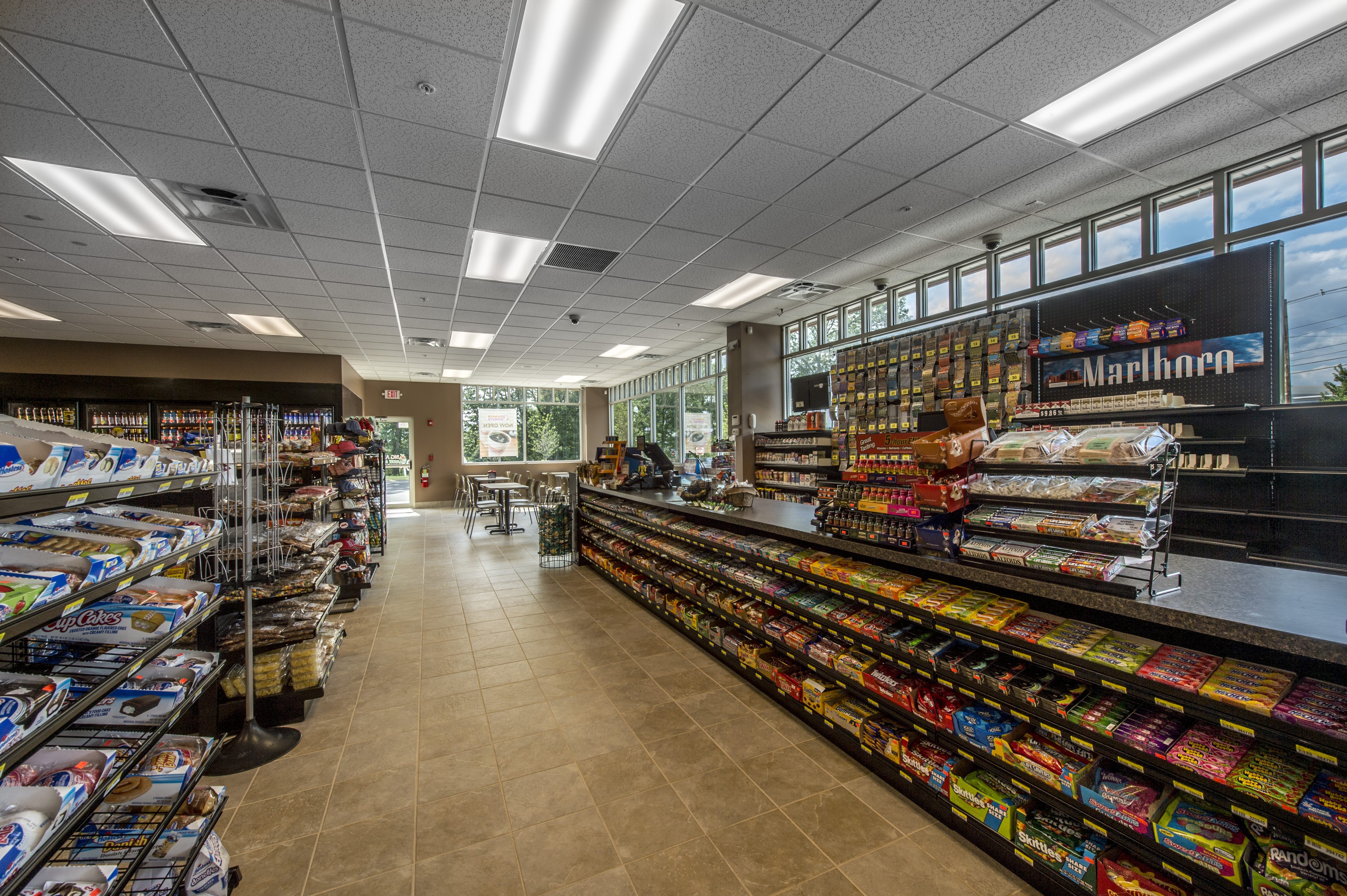 chocolates and biscuits are arranged in racks in super market