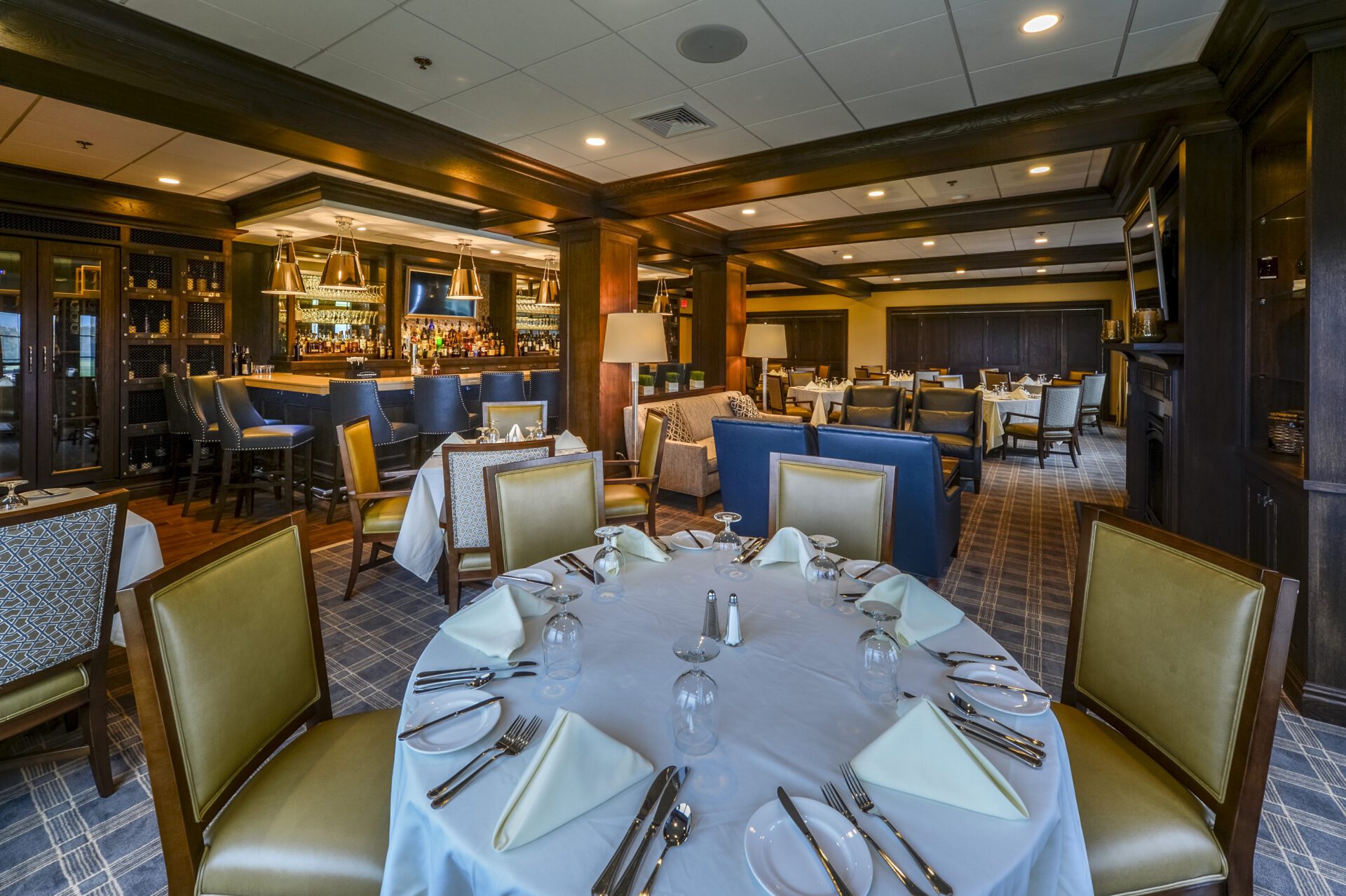 A restaurant with gold chairs and white table