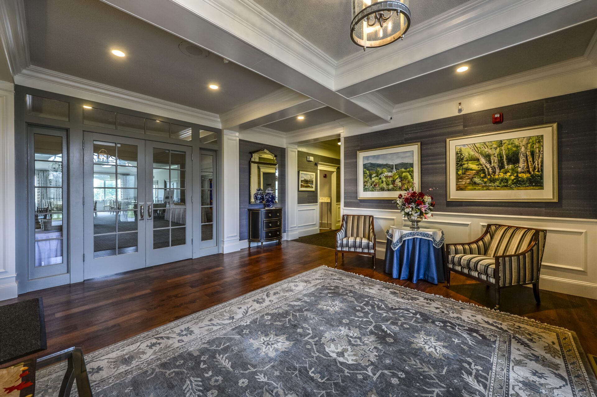 A living room with sofas and beautiful painting hanged in wall