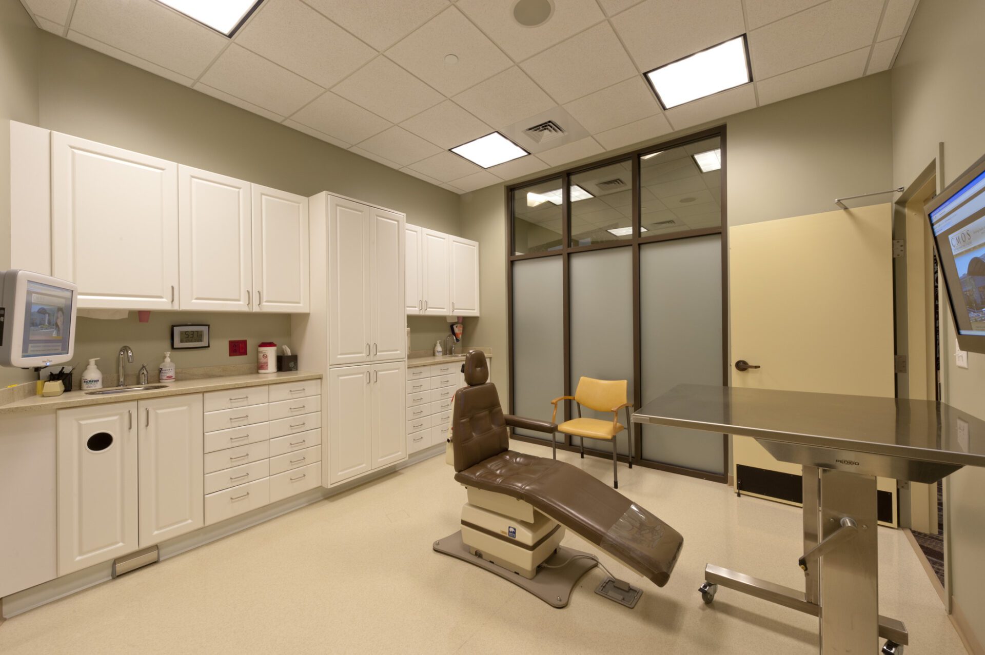 A brown dental chair in a room